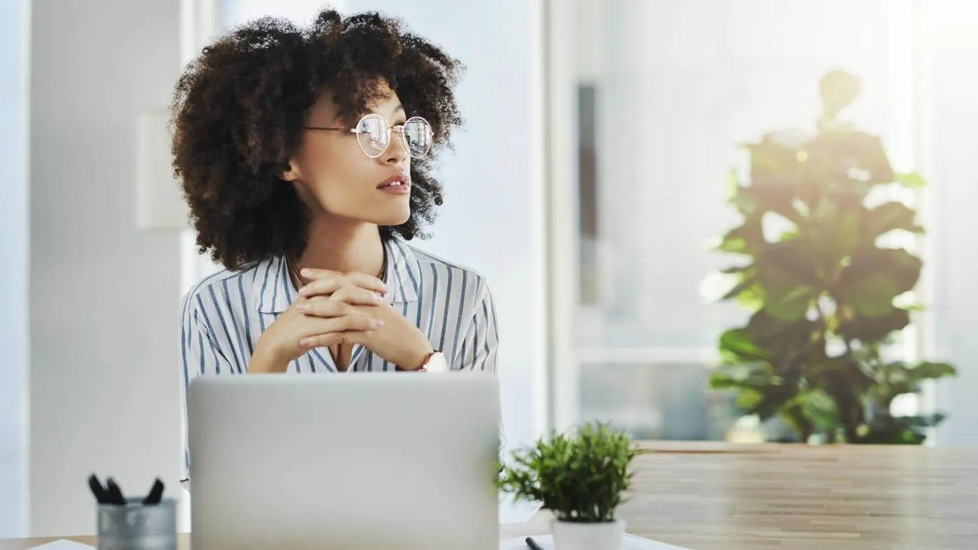 Woman looking off while working on computer