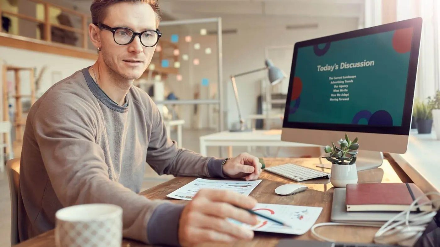 Man working on a webinar slide presentation.