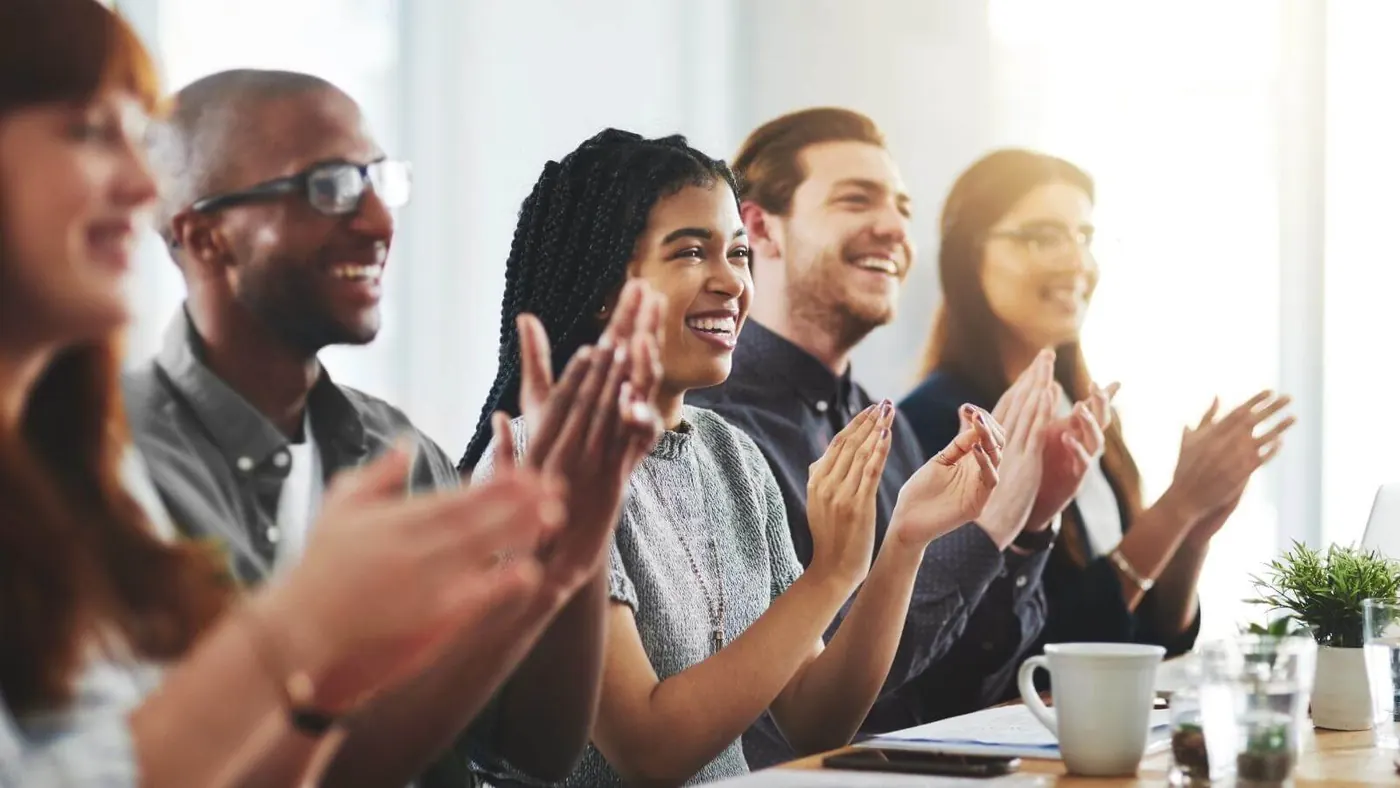 Employees smiling and clapping