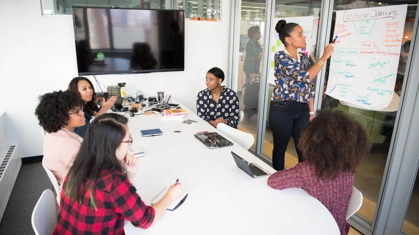 women-colleagues-inside-conference-room-planning-webinars-as-engagement-tools