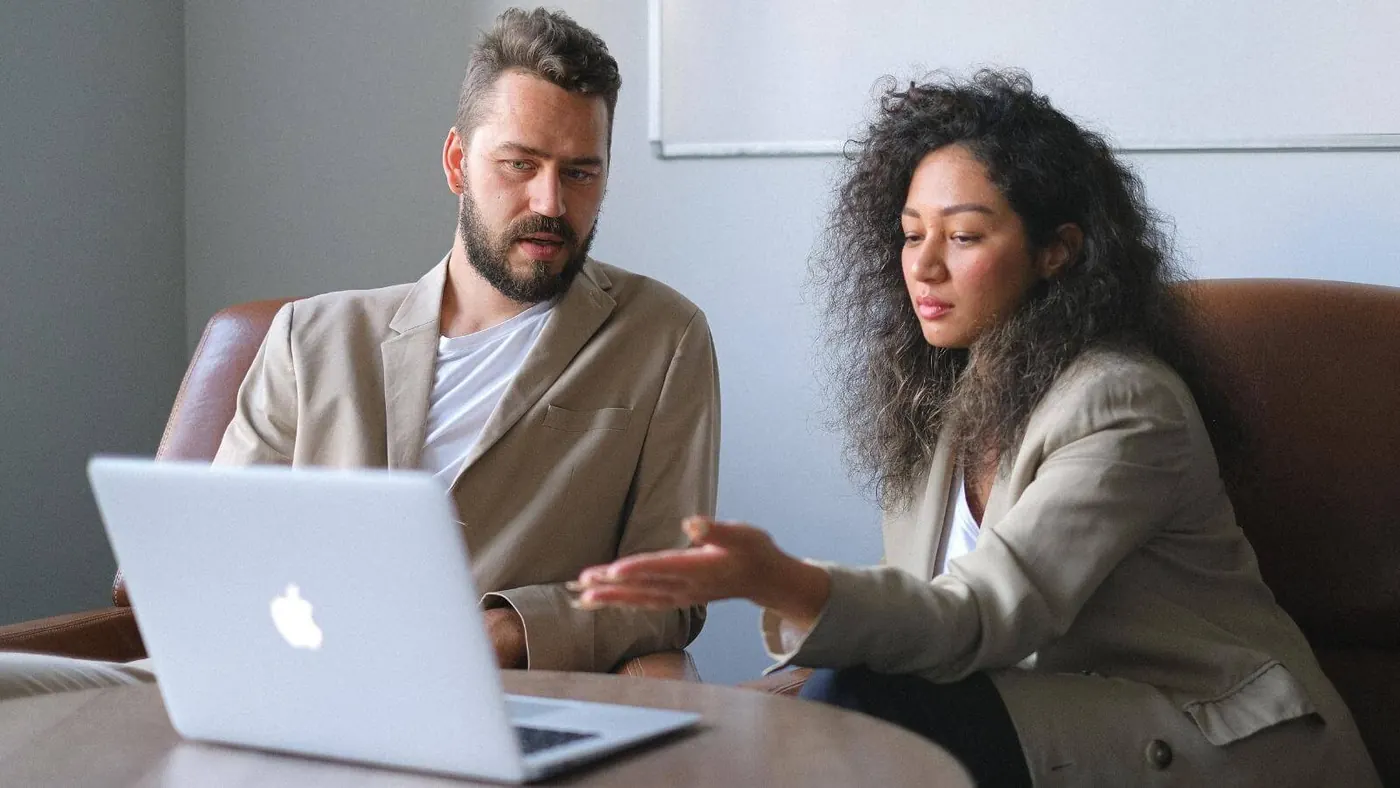 focused-man-working-with-female-colleague-in-office