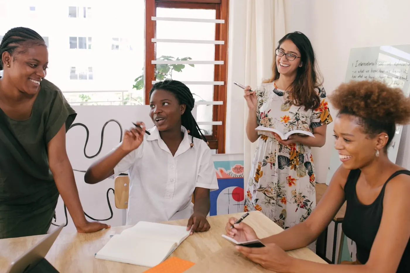 Marketers working together, smiling and planing for stages in the emotional buyer's journeyy