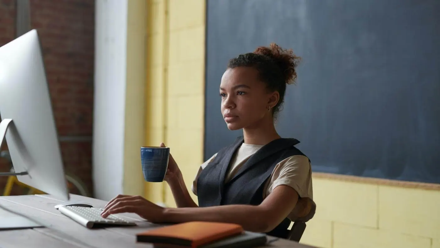 photo-of-woman-holding-mug-while-working