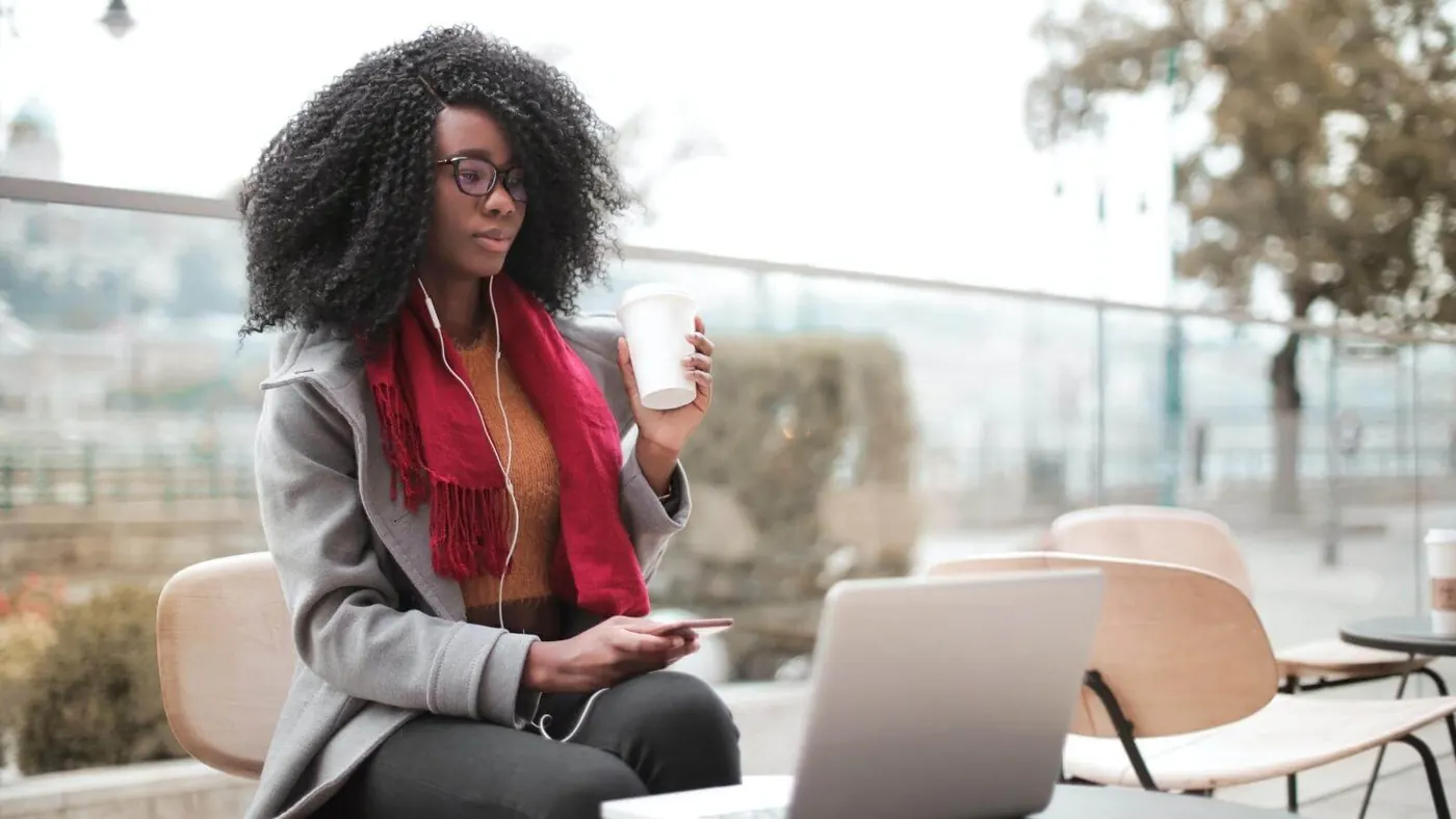 woman-drinking-coffee-working-outside